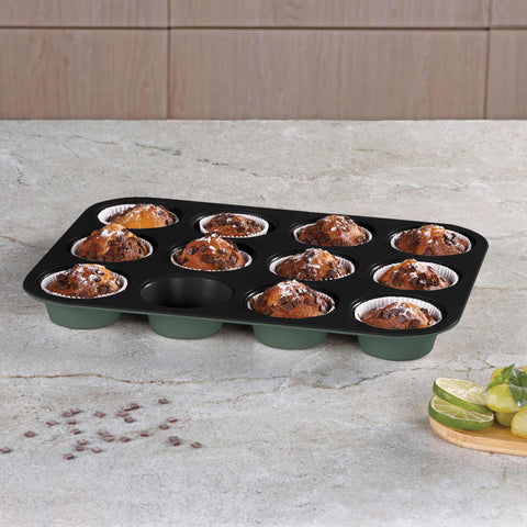 Product image of 12cups muffin pan. Part of the Matte Green Collection . Features: • Material: carbon steel with titanPro non-stick coating • Size: 35*26,5*3 cm • Color: matt green. (Studio view). Official Berlinger Haus product, boosted by Promintra sl.