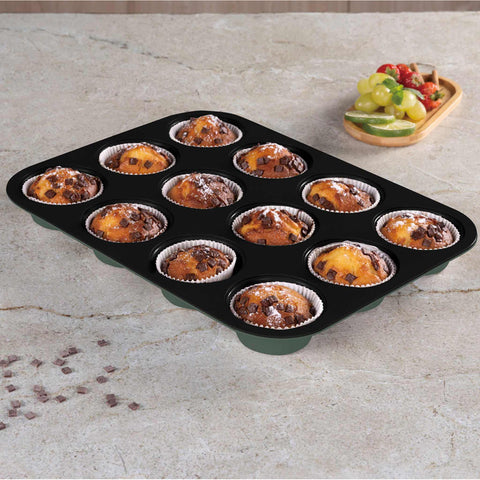 Product image of 12cups muffin pan. Part of the Matte Green Collection . Features: • Material: carbon steel with titanPro non-stick coating • Size: 35*26,5*3 cm • Color: matt green. (Studio view). Official Berlinger Haus product, boosted by Promintra sl.
