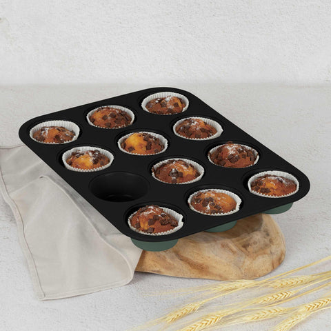 Product image of 12cups muffin pan. Part of the Matte Green Collection . Features: • Material: carbon steel with titanPro non-stick coating • Size: 35*26,5*3 cm • Color: matt green. (Studio view). Official Berlinger Haus product, boosted by Promintra sl.