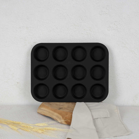 Product image of 12cups muffin pan. Part of the Matte Green Collection . Features: • Material: carbon steel with titanPro non-stick coating • Size: 35*26,5*3 cm • Color: matt green. (Studio view). Official Berlinger Haus product, boosted by Promintra sl.