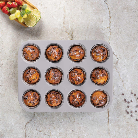 Product image of 12cups muffin pan. Part of the Taupe Collection . Features: • Material: carbon steel with titanPro non-stick coating • Size: 35*26,5*3 cm • Color: matt taupe. (Studio view). Official Berlinger Haus product, boosted by Promintra sl.