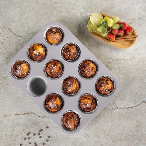Product image of 12cups muffin pan. Part of the Taupe Collection . Features: • Material: carbon steel with titanPro non-stick coating • Size: 35*26,5*3 cm • Color: matt taupe. (Studio view). Official Berlinger Haus product, boosted by Promintra sl.