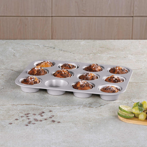 Product image of 12cups muffin pan. Part of the Taupe Collection . Features: • Material: carbon steel with titanPro non-stick coating • Size: 35*26,5*3 cm • Color: matt taupe. (Studio view). Official Berlinger Haus product, boosted by Promintra sl.