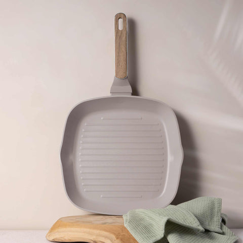 Product image of Grill pan 28cm. Part of the Taupe Nordic Collection . Features: • Material: forged aluminum with non-stick titanPro coating • Grill pan Ø28*4,1 cm 2,1L • Color: matt taupe, wooden REGISTERED DESIGN BY BERLINGER .... (Studio view). Official Berlinger Haus product, boosted by Promintra sl.