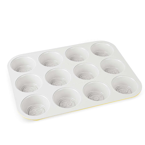 Product image of 12cups muffin pan. Part of the Minions Collection . Features: • Material: carbon steel with titanPro non-stick coating • Size: 35*26,5*3 cm • Color: yellow. (Studio view). Official Berlinger Haus product, boosted by Promintra sl.