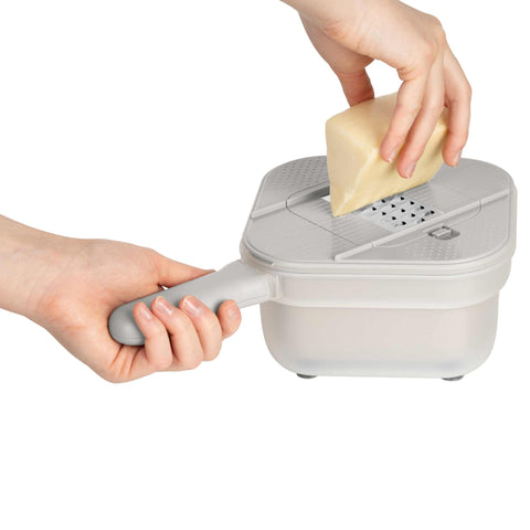 Product image of Multifunctional slicer. Part of the Sahara Collection . Features: • Material: stainless steel, plastic • Capacity: 1,5 L • Size: 18*18*11,5 cm • With 3 different blades • Color: cream. (Studio view). Official Berlinger Haus product, boosted by Promintra sl.