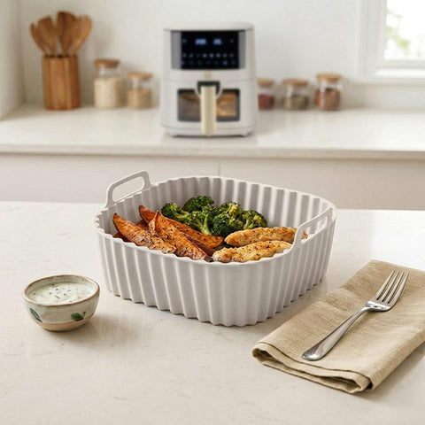 Product image of Silicone air fryer basket. Part of the Sahara Collection . Features: • Air fryer basket • Material: silicone • Size: 21*21*9 cm • Color: cream. (Studio view). Official Berlinger Haus product, boosted by Promintra sl.