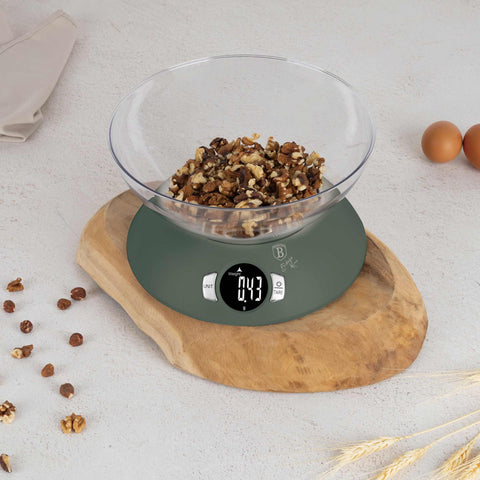 Product image of Kitchen scale with bowl. Part of the Matte Green Collection . Features: • Material: plastic • LCD display • Capacity: 5 kg • AAA battery included • Accessories: • Measuring cup: 25 ml • Egg separator • Color: matt green. (Conceptual view). Official Berlinger Haus product, boosted by Promintra sl.