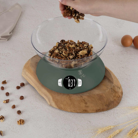 Product image of Kitchen scale with bowl. Part of the Matte Green Collection . Features: • Material: plastic • LCD display • Capacity: 5 kg • AAA battery included • Accessories: • Measuring cup: 25 ml • Egg separator • Color: matt green. (Conceptual view). Official Berlinger Haus product, boosted by Promintra sl.