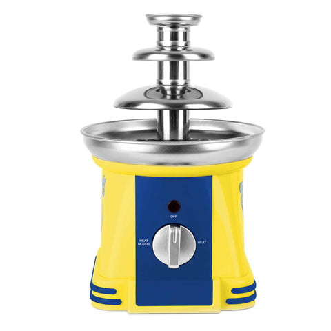 Product image of Chocolate fountain. Part of the Minions Collection . Features: • Material: stainless steel, plastic • 220-240 V, 50/60Hz, 32 W • Capacity: 50g • Size: 15*15*24 cm • Length of power cord: 1 m • Color: yellow- blue. (Studio view). Official Berlinger Haus product, boosted by Promintra sl.