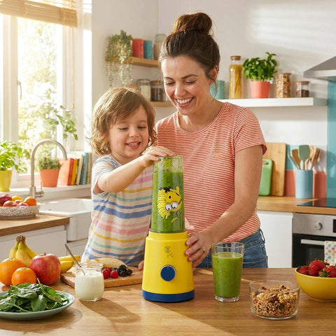Product image of Smoothie maker. Part of the Minions Collection . Features: • Material: stainless steel, plastic • Power: 320 W • 220-240 V 50/60 Hz • 2 pcs takeaway jar with lid: 300 ml and 600 ml • Color: yellow- blue. (Studio view). Official Berlinger Haus product, boosted by Promintra sl.