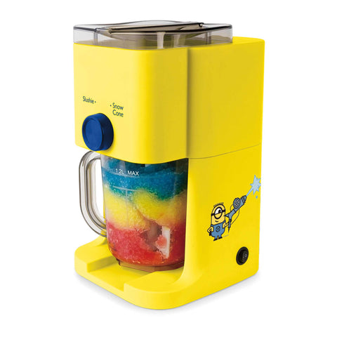 Product image of Slushie maker. Part of the Minions Collection . Features: • Power: 30W • Voltage: 220-240V, 50/60 Hz • Jar capacity: 1,1L • Accessories: • Measuring cup • Stirring paddle • Color: yellow- blue. (Studio view). Official Berlinger Haus product, boosted by Promintra sl.
