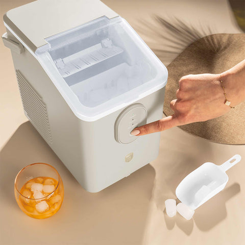 Product image of Ice cube maker. Part of the Sahara Collection . Features: • Power: 120W • Voltage: 220-240V, 50/60Hz • 0,8L water tank • Accessories: • Ice scoop • Ice basket • Length of power cord: 1,2 m • Color: cream. (Studio view). Official Berlinger Haus product, boosted by Promintra sl.