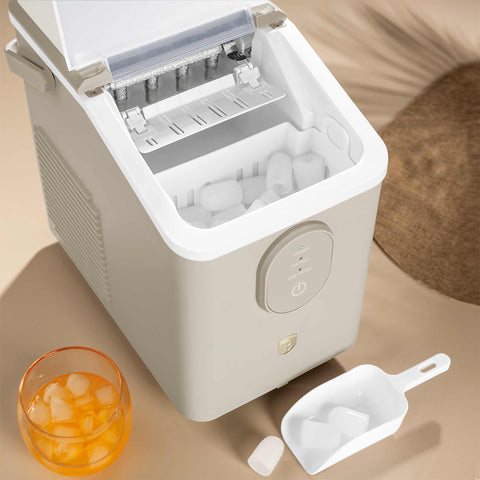 Product image of Ice cube maker. Part of the Sahara Collection . Features: • Power: 120W • Voltage: 220-240V, 50/60Hz • 0,8L water tank • Accessories: • Ice scoop • Ice basket • Length of power cord: 1,2 m • Color: cream. (Studio view). Official Berlinger Haus product, boosted by Promintra sl.
